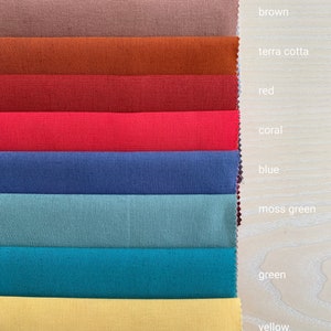 May include: A fabric swatch card with 10 different colors of fabric. The colors are burgundy, brown, terra cotta, red, coral, blue, moss green, green, yellow, and a light yellow.