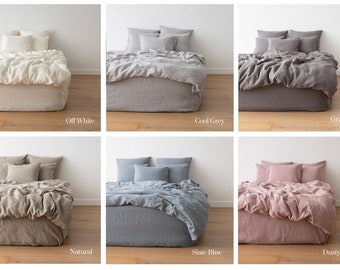 May include: Six different linen duvet covers displayed on beds with matching pillowcases. The colors are Off-White, Cool Grey, Graphite, Natural, Slate Blue, and Dusty Rose.