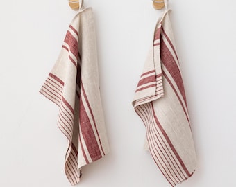 May include: Two red and white striped linen kitchen towels hanging on hooks.