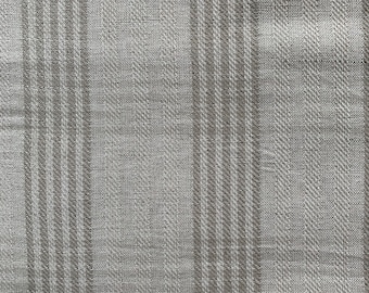 May include: A close-up of a gray and white striped fabric with a subtle woven texture.
