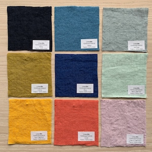 May include: Nine fabric swatches in various colors, including navy, blue, green, yellow, orange, and pink. Each swatch has a label with the text "LinenMe TERRA&FRINGE" and the color name, followed by "Fabric: 100% linen".