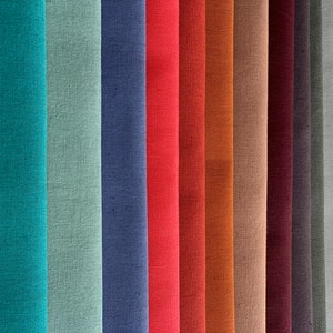 May include: A collection of fabric swatches in various colors, including yellow, teal, green, blue, red, orange, brown, beige, burgundy, gray, and white. The fabric has a linen texture.