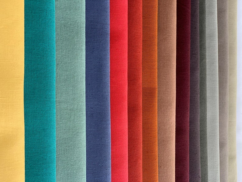 May include: A collection of fabric swatches in various colors, including yellow, teal, green, blue, red, orange, brown, beige, burgundy, gray, and white. The fabric has a linen texture.
