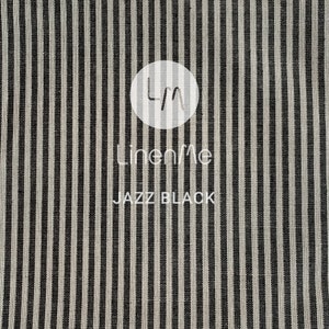 May include: Black and white striped fabric with the text "LinenMe" and "Jazz Black" printed on it.