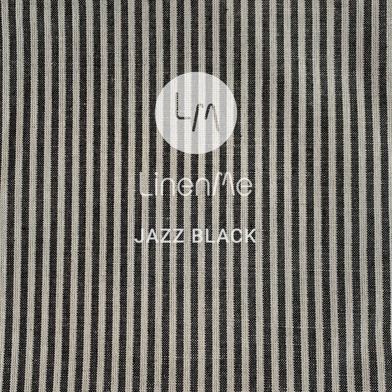 May include: Black and white striped fabric with the text "LinenMe" and "Jazz Black" printed on it.