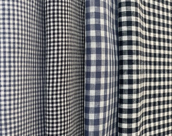 Könnte beinhalten: Vier Rollen schwarzer und weißer Gingham-Stoff, jede mit einer anderen Karogröße.