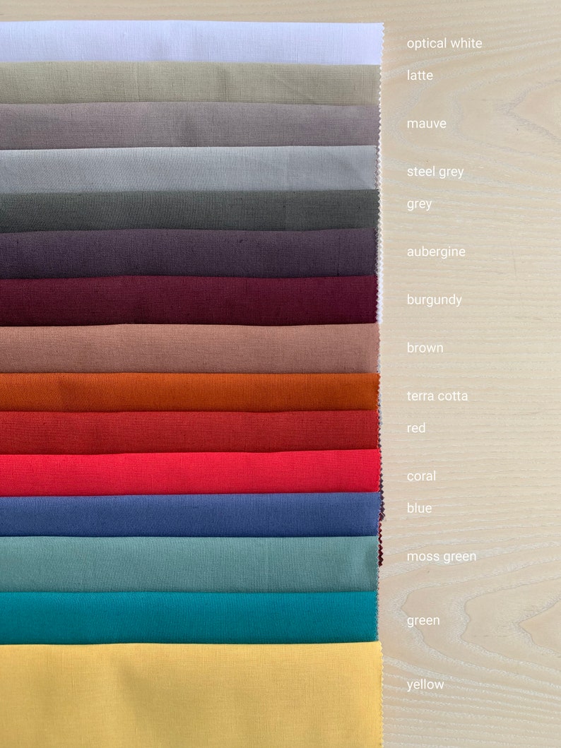 May include: A fabric swatch card with 15 different colors, including optical white, latte, mauve, steel grey, grey, aubergine, burgundy, brown, terra cotta, red, coral, blue, moss green, green, and yellow.