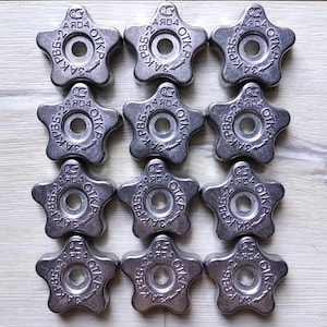 May include: Twelve silver star-shaped weight plates with the text "PB5-2 AЯD4 OTKP 3A" on each plate.