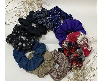 May include: A set of ten colorful scrunchies made from fabric with different patterns. The scrunchies are arranged in a circle.