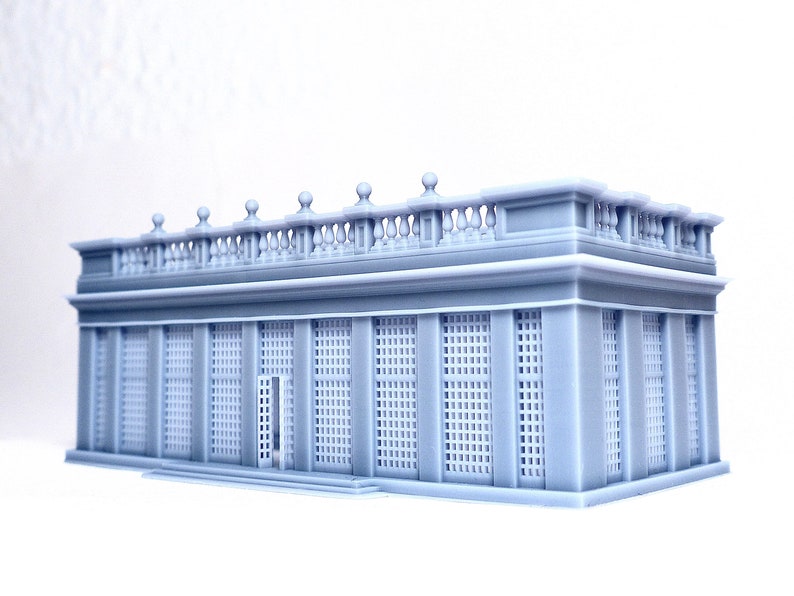 May include: A gray 3D printed model of a classical building with a balcony and a series of windows with a grid pattern.