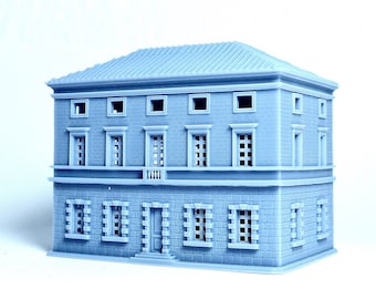 May include: A gray, two-story, miniature building with a flat roof and multiple windows. The building has a stone facade and a small balcony on the second floor.