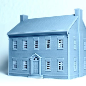 May include: A grey 3D printed model of a two-storey brick house with a front door and windows.