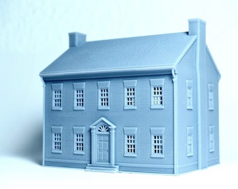 May include: A gray 3D printed model of a two-story brick house with a front door and windows.
