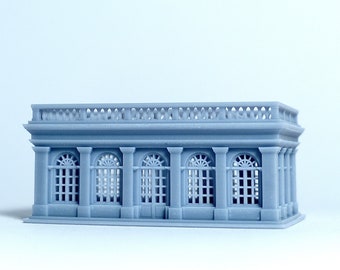 May include: A gray 3D printed model of a building with a balcony and arched windows.