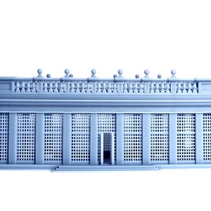May include: A gray 3D printed model of a classical building with a balcony and a latticework facade.