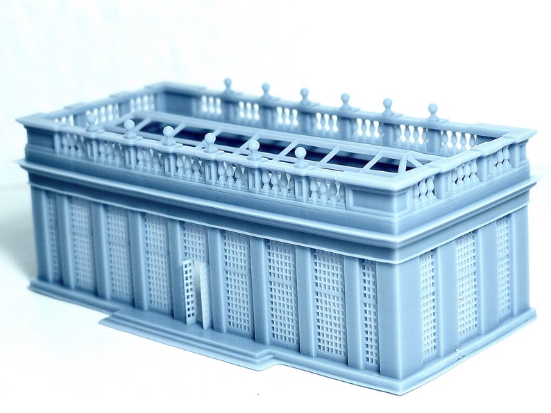May include: A gray 3D printed model of a building with a detailed roof and a balcony. The building has a glass roof and a series of windows with a grid pattern.
