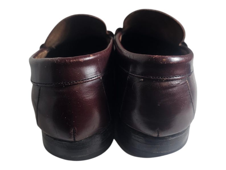 May include: A pair of brown leather loafers with a dark brown sole. The loafers have a classic design and are made of high-quality leather.