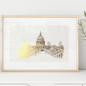 Può includere: Un disegno in bianco e nero incorniciato della Cattedrale di San Paolo a Londra, in Inghilterra. Il disegno è in una cornice dorata ed è appeso a un muro bianco.