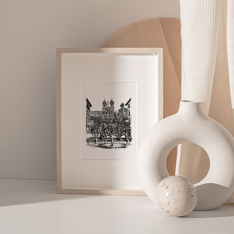 May include: A black and white line drawing of the Spanish Steps in Rome, Italy, framed in a white frame.
