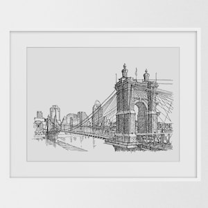 May include: Black and white line drawing of a suspension bridge over a river with buildings in the background.