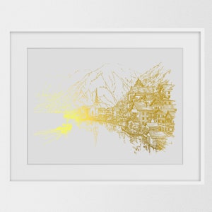 May include: A framed art print featuring a gold-toned illustration of a lakeside village with mountains in the background. The artwork has a detailed, sketched style, with a bright yellow and gold gradient effect on the left side. The print is set in a white frame.