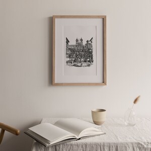 May include: A black and white line drawing of the Spanish Steps in Rome, Italy. The drawing is framed in a light wood frame and is hanging on a white wall.