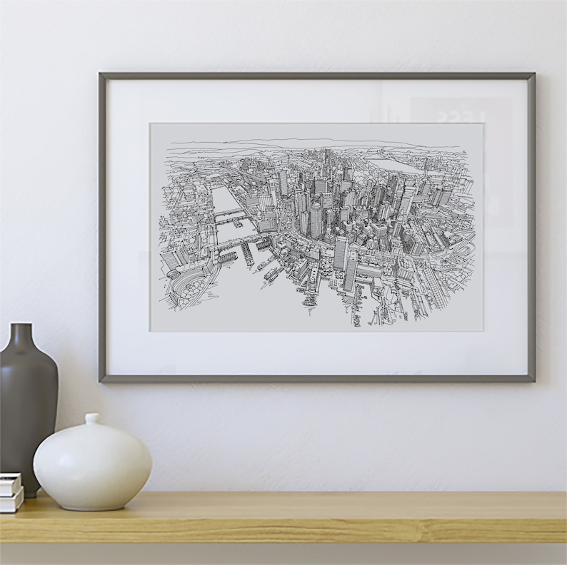 May include: A black and white line drawing of a city skyline, framed in a gray frame. The drawing depicts a city with tall buildings, a river, and bridges.