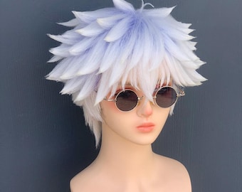 May include: A white and light blue spiky wig with a layered design. The wig is styled on a mannequin head, which is also wearing round, gold-rimmed sunglasses with dark lenses. The background is a solid, dark gray.