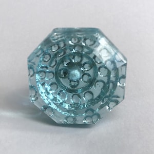 May include: A light blue glass cabinet knob with a decorative, circular pattern.