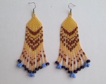 Long yellow beaded earrings with small blue flowers at the ends of fringes. Long boho earrings for bohemian wedding.