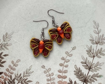 Small brown and yellow moth earrings with sculpted ornament. Colourful dangle-drop earrings with hand sculpted painted butterfly.
