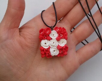 Handmade swiss national flag necklace cowered with hand sculpted flowers.