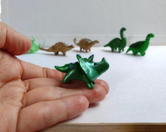 Tiny dinosaur figurine in green. Triceratops dinosaur figurine. Small sculpture of dinosaur. Pocket size toy companion.