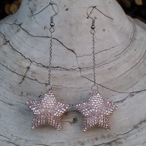 Long dangle star earrings in pink blush, which will make you star of a party. Beaded star earrings for woman or girl.