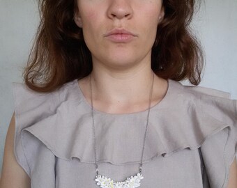 White floral necklace made of small hand sculpted flowers. Tender wedding flowered necklace on chain.