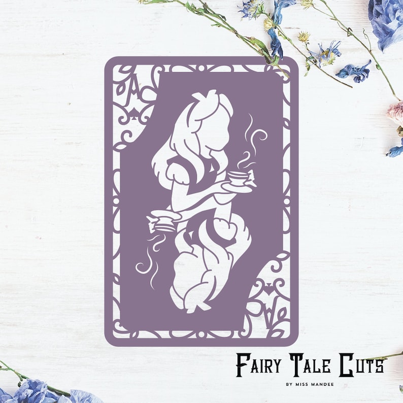 May include: Purple card with a white silhouette of Alice in Wonderland holding a teacup. The card has a decorative border and the text "Fairy Tale Cuts" at the bottom.