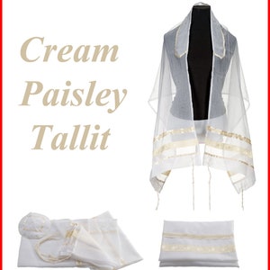 May include: A cream-coloured tallit featuring a paisley pattern, displayed on a mannequin and folded. The set includes a matching kippah and a bag. The text 'Cream Paisley Tallit' is visible on the left side of the image, describing the prayer shawl.