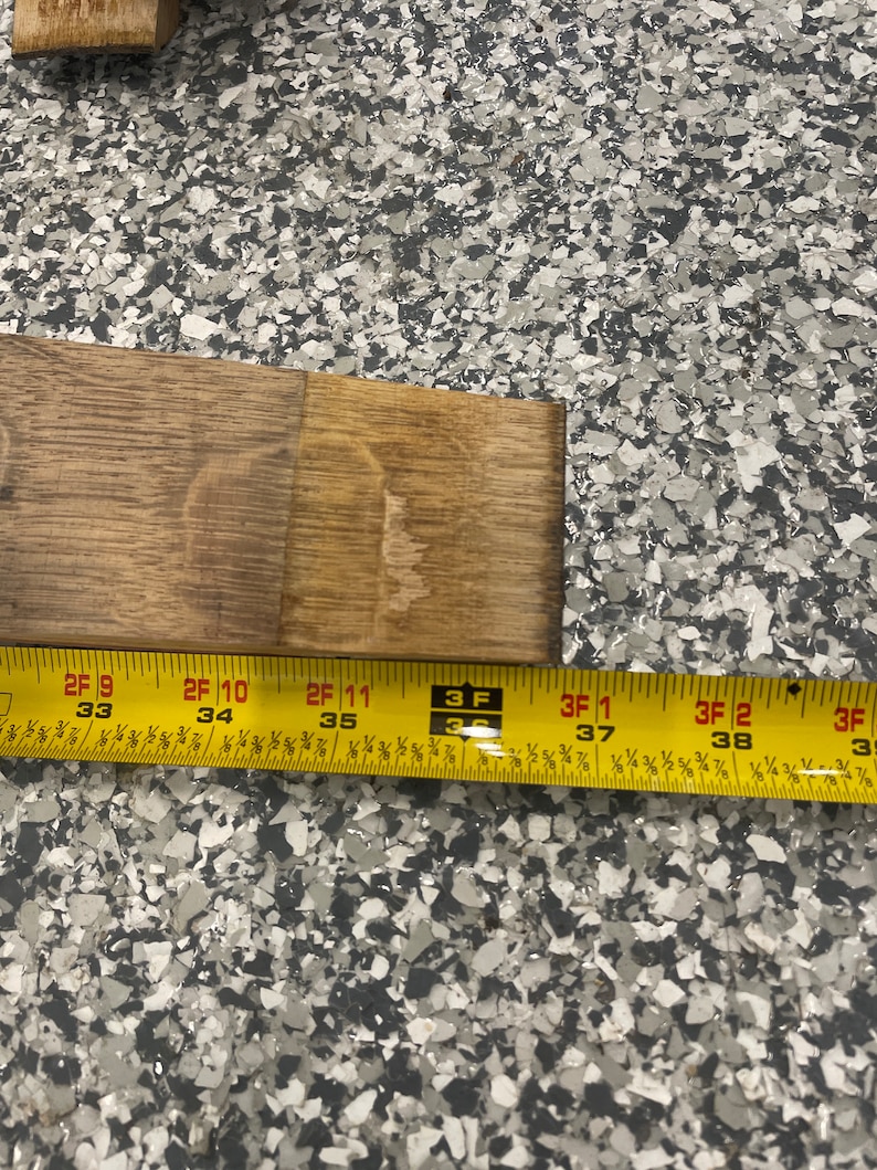 May include: Close-up of a yellow measuring tape with black markings. The tape reads "2F 9 33", "2F 10 34", "2F 11 35", "3 F 3", "3F 1 37", "3F 2 38", and "3F 3".