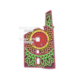 May include: A red, yellow, and green layered paper cut design of a building with a chimney. The building is decorated with intricate mandala patterns.