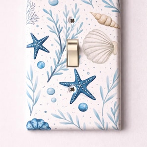 Tapa para interruptor de luz con diseño de estrella de mar y coral, ideal para decoración de guardería o casa de playa. Nylon irrompible.