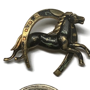 Copper brooch with horse and horseshoe