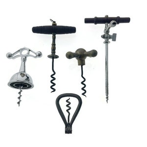 May include: A set of four vintage corkscrews with different designs. The corkscrews are made of metal and wood and have a variety of finishes, including silver, brass, and black.
