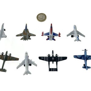 8 different metal military planes