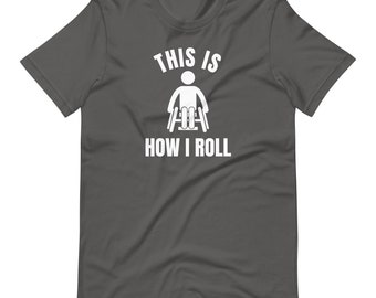 May include: A dark gray t-shirt with white text that reads "This is how I roll" and a white silhouette of a person in a wheelchair.