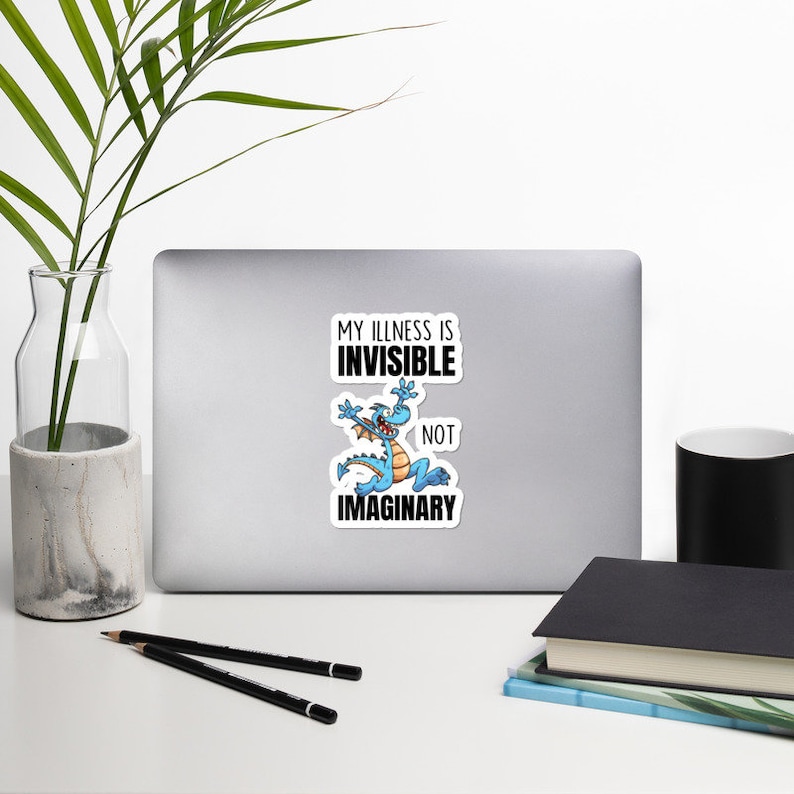 May include: A sticker with a blue cartoon dragon and the text "My illness is invisible, not imaginary."