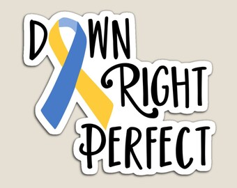 May include: A yellow and blue ribbon with the text "Down Right Perfect" in black. The ribbon is a symbol of Down's syndrome awareness.