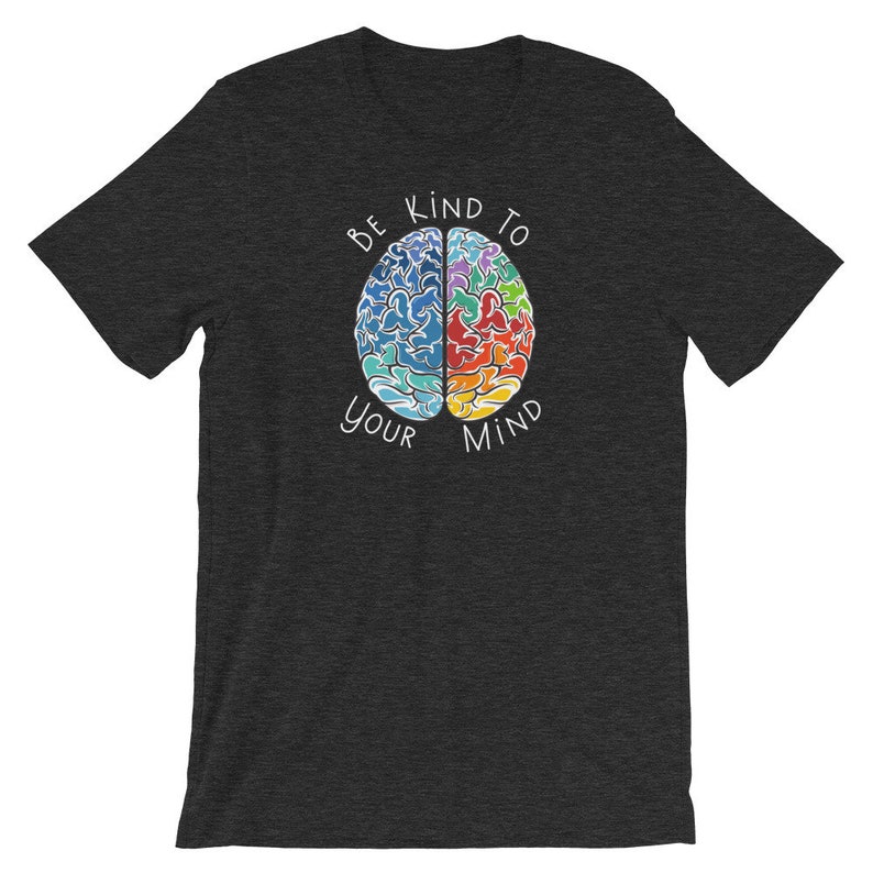 May include: A dark heather grey t-shirt with a colorful brain graphic and the text "Be Kind To Your Mind".