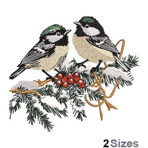 May include: An embroidered design featuring two birds perched on a snow-covered branch with red berries. The birds have black, white, and tan feathers with green accents. The text "2 Sizes" is at the bottom.