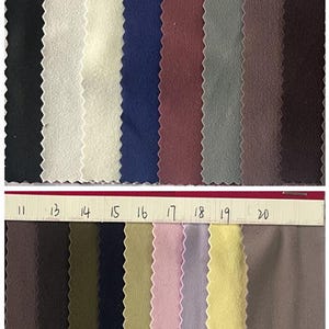 May include: Swatch card showing 20 different fabric colors. The fabric is a 4-way stretch, 77% polyester and 23% spandex, 250gsm single side brushed soft fabric.