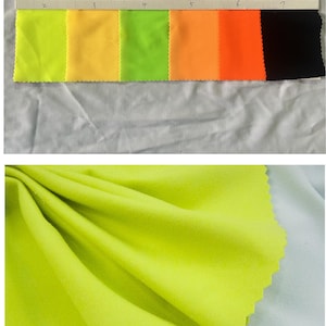 Puede incluir: Una carta de muestras con siete colores diferentes de tela. Los colores son: amarillo neón, amarillo, verde lima, naranja, rojo, negro y blanco. La tela es un material liso y tejido.